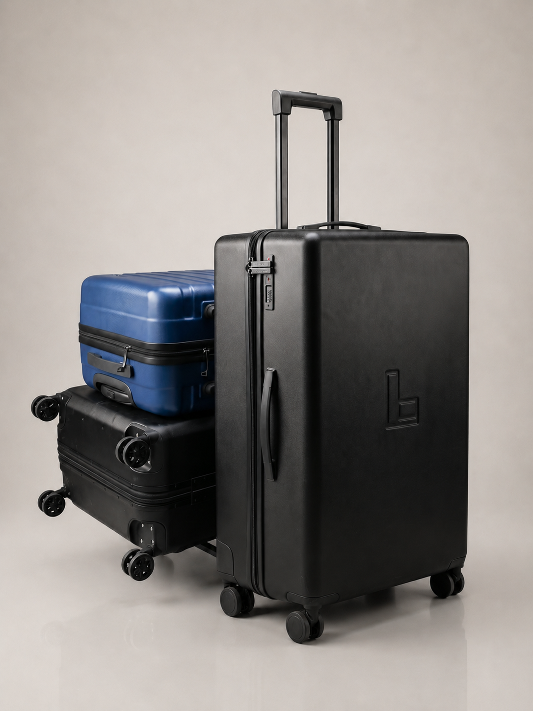 Close-up of the trolley suitcase's replaceable matte-black spinner wheels